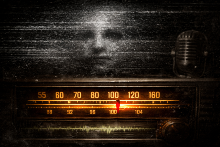 Wide-format featured image of a vintage analog radio glowing amber in darkness, tuning needle between stations, with black-and-white static and a faint ghostly face emerging above, evoking retro late-night broadcast atmosphere